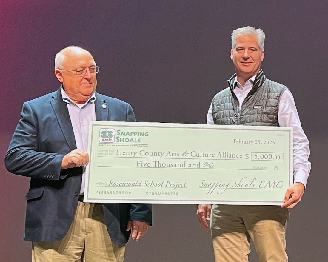 Man presents check