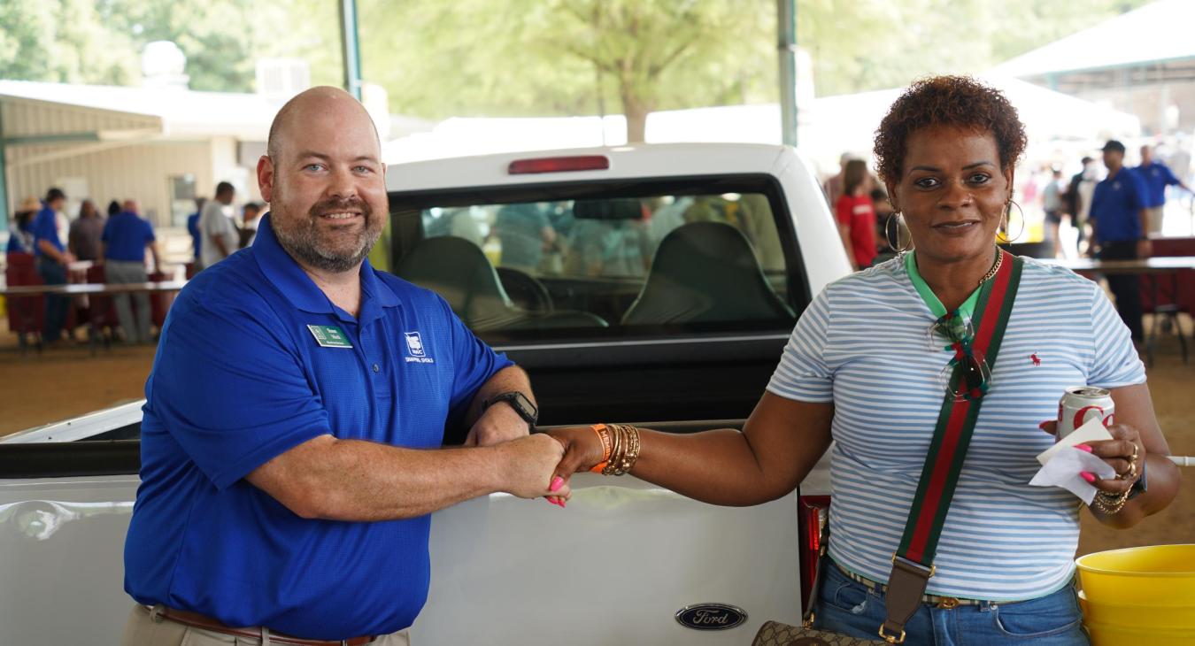 President and CEO Shaun Mock with this year's winner of the pickup truck raffle.